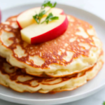 A delicious plate of Farmers Cheese Pancakes with Apple (Syrniki)
